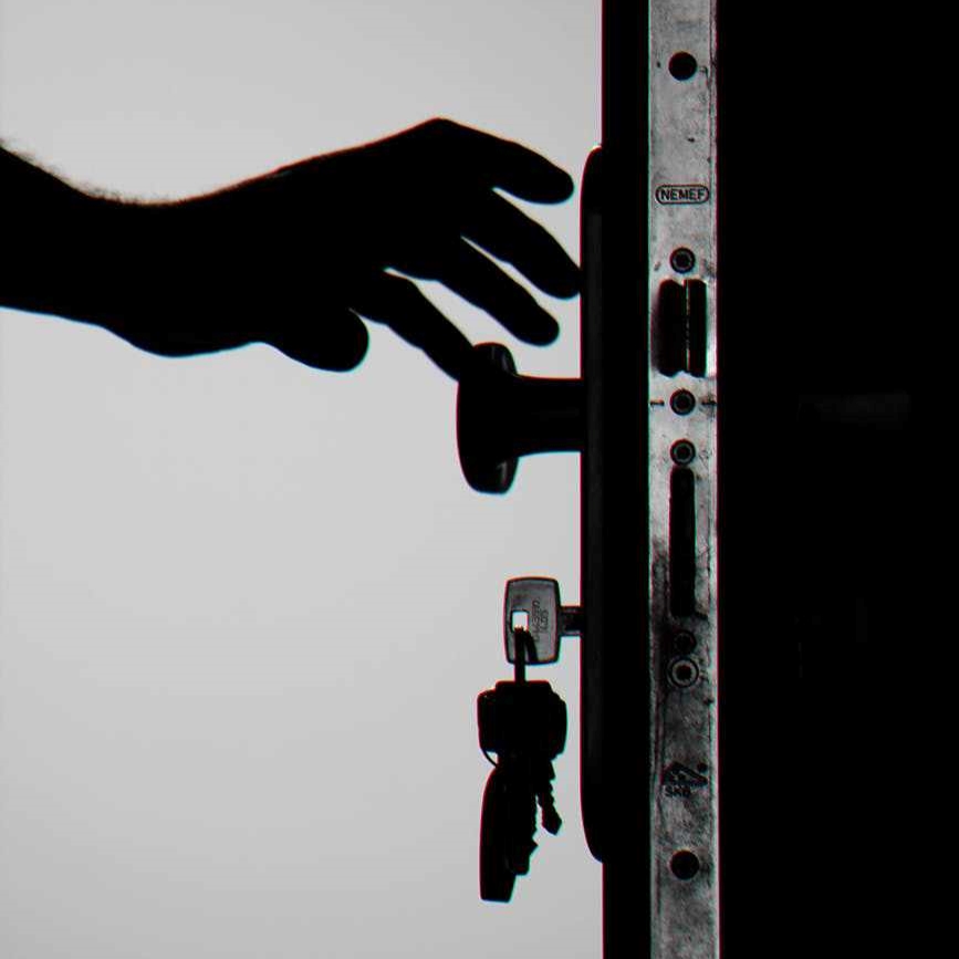 a silhouette of a hand reaching for a doorknob signifying domestic abuse